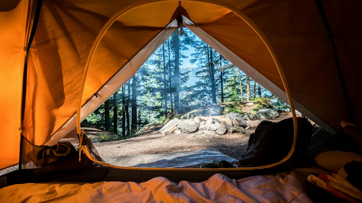 Best Portable Camping Lanterns Reviewed 2025 2 Scenic campsite surrounded by trees ready for evening lighting